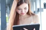 Portrait Of Thai Adult Beautiful Girl Using Her Tablet And Smile In University Stock Photo