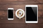 White Phone Tablet And Coffee Cup On Wood Table Top View Stock Photo