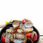 Fresh Clams On An Iron Skillet Stock Photo