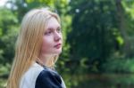 Head Of Blond Girl With Water And Trees Stock Photo