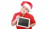 Child With Santa Hat And Tablet Pc Stock Photo