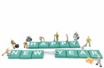 Miniature Worker Team Building Word Happy New Year On White Background Stock Photo