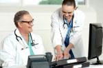 Smiling Doctor Working On Computer Stock Photo