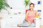 Woman At Home On Sofa With Fruits Stock Photo