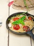 Spaghetti Pasta With Baked Cherry Tomatoes And Basil Stock Photo