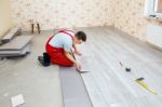 Handyman Laying Down Laminate Flooring Boards Stock Photo