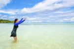 Happy Asian Teen Girl Play Splashing Water In The Sea Stock Photo