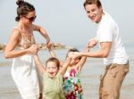 Family Playing On The Beach Stock Photo