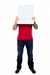 Man Hiding Face With Blank Board Stock Photo