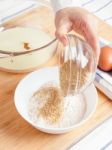 Woman Pouring Ground Flaxseed Into Flour Stock Photo