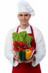 Young Chef Holding Vegetables Bowl Stock Photo