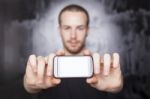 Young Man Showing Smartphone Stock Photo