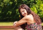 Portrait Of A Young Beautiful Brunette In A City Park Stock Photo