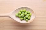 Peas On Wooden Spoon Stock Photo