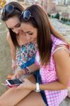 Beautiful Girls Sitting On The Roof And Listening To Music At Su Stock Photo