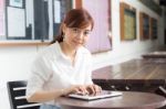 Portrait Of Thai Adult Businesswoman Beautiful Girl Using Her Tablet Stock Photo