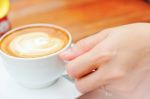 Woman Hand With A White Cup Coffee Stock Photo