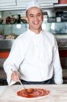 Smiling Chef Making Pizza Stock Photo