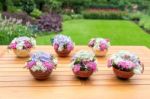 Vases With Blooming Flowers On Teak Table Stock Photo