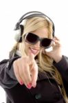 Girl Pointing forward With Earphone Stock Photo