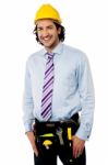 Smiling Male Architect Wearing Tool Belt Stock Photo