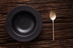 Black Empty Bowl Spoon On Wooden Table Background Stock Photo