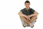 Teenage Student Sitting On Floor Stock Photo