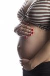 Woman Holding Her Pregnant Belly. White Background Stock Photo