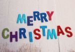 Merry Christmas Word On Wooden Background With Snow Stock Photo