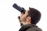 Male looking through binoculars Stock Photo