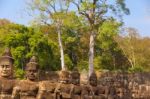 Statues Of Ancient Khmer Warrior Heads Carry Giant Snake Decorat Stock Photo