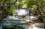 The Water Flowing Over Rocks And Trees Down A Waterfall At Huay Mae Khamin Waterfall National Park ,kanchana Buri In Thailand Stock Photo