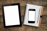 Tablet And Smartphone On Wood Background Stock Photo