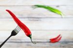 Red Hot Chili Pepper With Water Drops On Fork Stock Photo