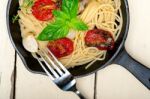 Spaghetti Pasta With Baked Cherry Tomatoes And Basil Stock Photo