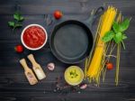 The Thin Spaghetti On Black Wooden Background. Yellow Italian Pa Stock Photo