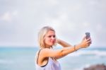 Beautiful Young Blonde Woman Posing Outdoor At The Rocky Sea Sho Stock Photo