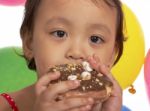 Kid Eating Donut At Party Stock Photo