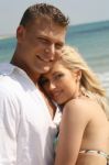 Caucasian Young Couples At Beach Stock Photo