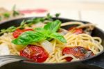 Spaghetti Pasta With Baked Cherry Tomatoes And Basil Stock Photo