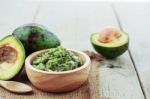 Avocado On Wooden Floor Stock Photo