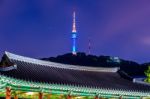 Namsangol Hannok Village And Seoul Tower Located On Namsan Mountain At Night In Seoul,south Korea Stock Photo