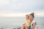 Asian Boy Pose On The Beach With His Mother Stock Photo