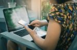 Woman Using Mobile Phone At Home Stock Photo