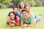 Happy Family Lying In The Park Stock Photo