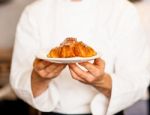 Chef Holding Fresh And Tasty Roll Croissants Stock Photo