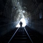 Man Standing In Train Tunnel Stock Photo