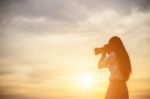 Women Nature Photographer With Digital Camera On The Mountain Stock Photo