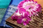 Traditional Brown Thai Fabric Pattern With Orchid Garland Stock Photo