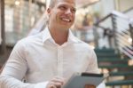 Man With Tablet Computer In Modern Business Building Stock Photo